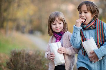 Image showing kids in park eating popcorn in park