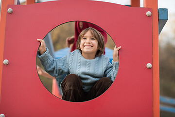 Image showing cute little boy having fun in playground