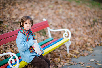 Image showing cute little boy in park eating popcorn