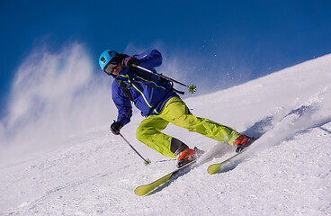 Image showing Skier having fun while running downhill