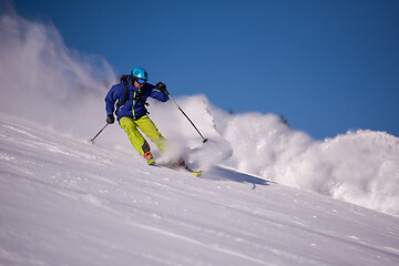 Image showing Skier having fun while running downhill