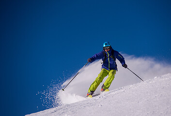 Image showing Skier having fun while running downhill