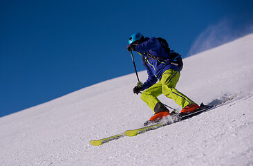 Image showing Skier having fun while running downhill