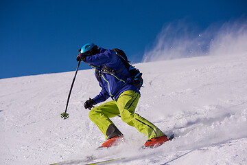 Image showing Skier having fun while running downhill