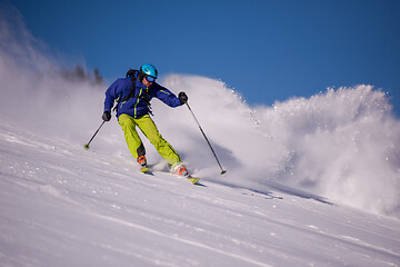 Image showing Skier having fun while running downhill