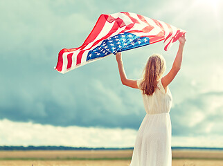 Image showing happy woman with american flag on cereal field