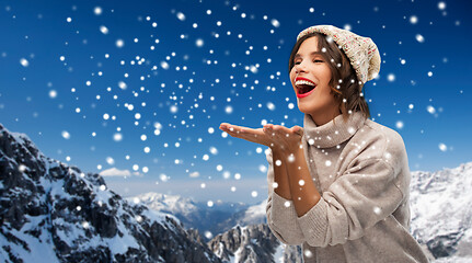 Image showing young woman in knitted winter hat in mountains