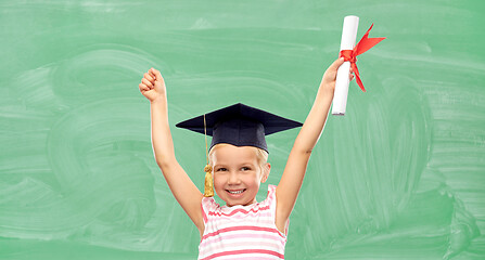 Image showing happy little girl in mortarboard with diploma