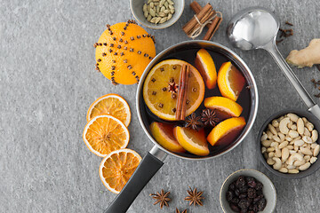 Image showing pot with hot mulled wine, orange slices and spices