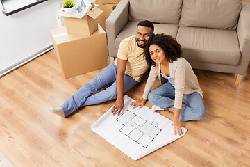 Image showing couple with boxes and blueprint moving to new home