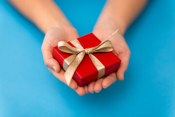 Image showing hands holding red small christmas gift box