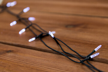 Image showing christmas garland lights on wooden background