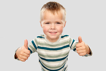 Image showing smiling boy in striped shirt showing thumbs up