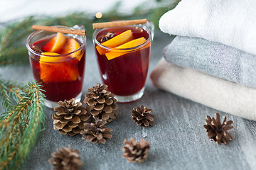 Image showing mulled wine with orange and spices, cones and fir