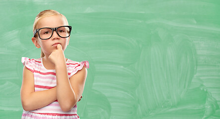 Image showing cute little girl in glasses thinking at school