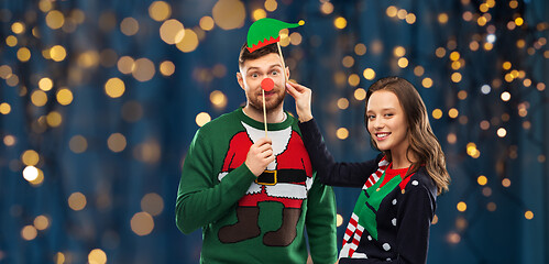 Image showing couple with christmas party props in ugly sweaters