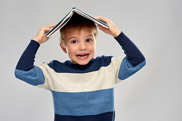 Image showing little boy with roof of book on top of his head