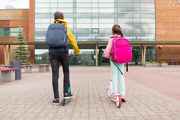 Image showing school children with backpacks and scooters