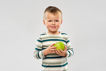 Image showing portrait of smiling boy holding green apple