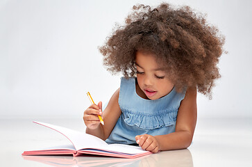 Image showing happy little african american girl with sketchbook