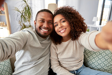 Image showing african american couple taking selfie at home