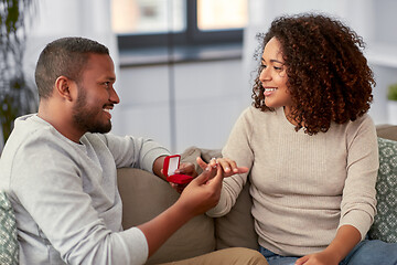 Image showing african american man giving woman engagement ring