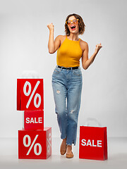 Image showing happy smiling young woman with shopping bags