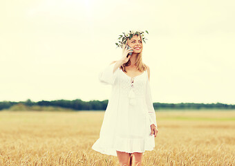 Image showing happy young woman calling on smartphone at country