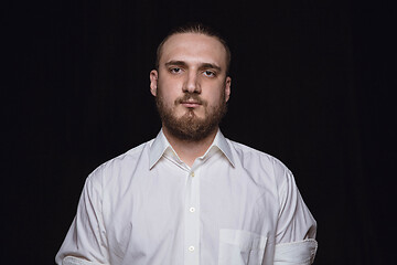 Image showing Close up portrait of young man isolated on black studio background