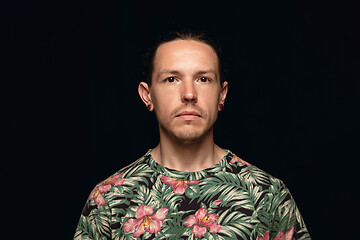 Image showing Close up portrait of young man isolated on black studio background