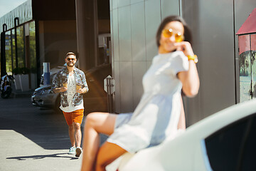 Image showing Young couple preparing for vacation trip on the car in sunny day