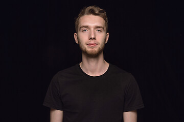 Image showing Close up portrait of young man isolated on black studio background