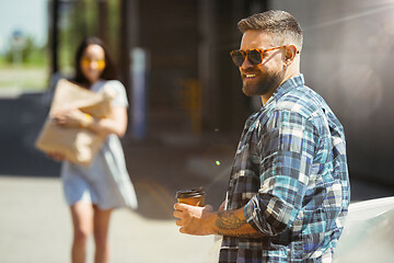 Image showing Young couple preparing for vacation trip on the car in sunny day