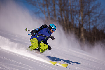 Image showing Skier having fun while running downhill