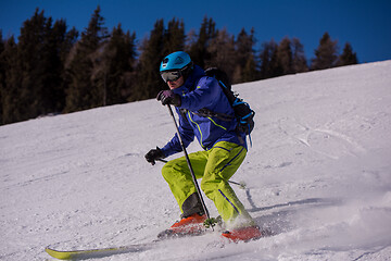 Image showing Skier having fun while running downhill