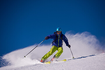 Image showing Skier having fun while running downhill