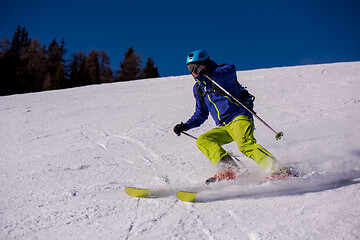 Image showing Skier having fun while running downhill