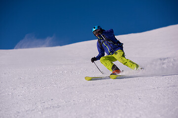 Image showing Skier having fun while running downhill