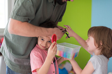 Image showing sister and brother havin fun and play hairstylist game at home