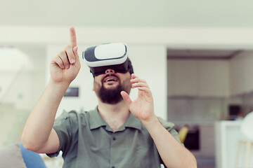 Image showing man with beard trying vr glasses