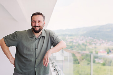 Image showing man standing on a modern balcony