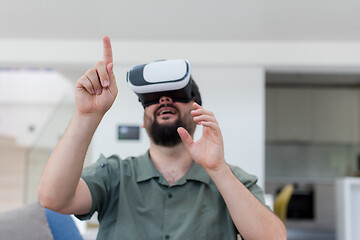 Image showing man with beard trying vr glasses