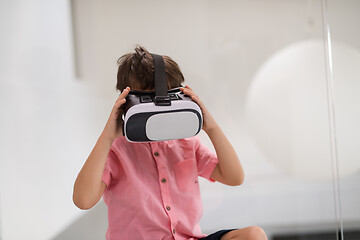 Image showing kid at home playing games on vr glasses