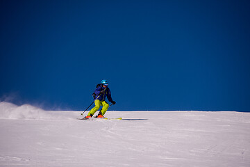 Image showing Skier having fun while running downhill