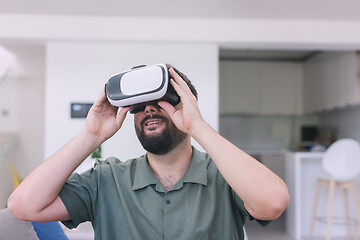 Image showing man with beard trying vr glasses