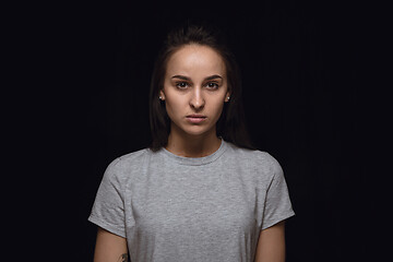 Image showing Close up portrait of young woman isolated on black studio background