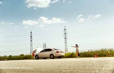 Image showing Young couple traveling on the car in sunny day