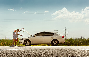 Image showing Young couple traveling on the car in sunny day