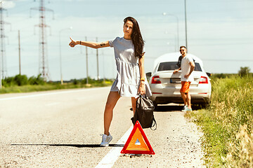 Image showing Young couple traveling on the car in sunny day