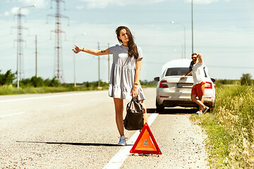 Image showing Young couple traveling on the car in sunny day